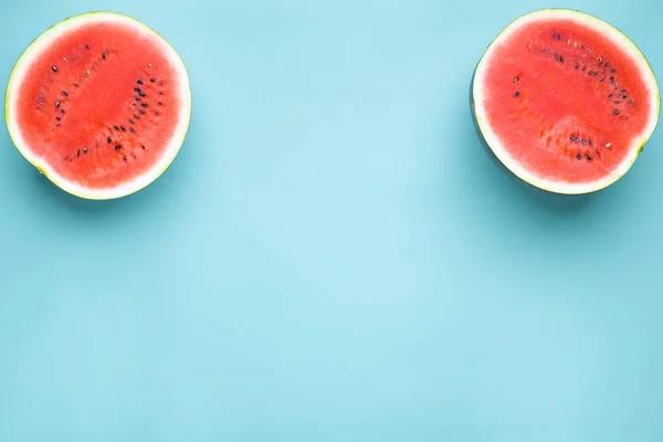 Colorful fruit minimal background of fresh juicy watermelon slices on blue background
