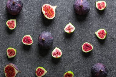 Fresh figs fruit. Purple fig slices, flat lay, top view.