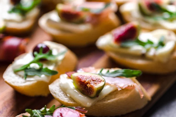 Tapas tradicionais de espanha ou bruschetta italiano com queijo, carne e figos. Comida de festa em bandeja de catering . — Fotografia de Stock