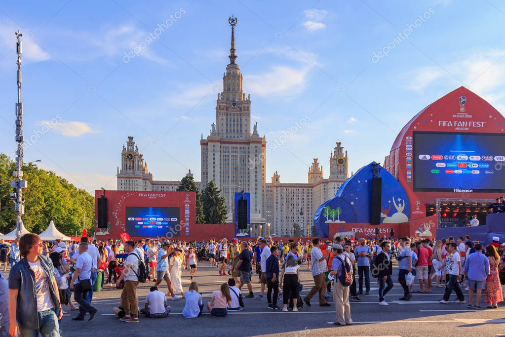 Moscow, Russia - June 28, 2018: Football fans on a background of Lomonosov Moscow State University on FIFA Fan Fest 2018