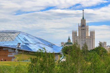 Moskova, Rusya - 21 Haziran 2018: Stalinist gökdelen üzerinde bir yaz sabahı büyük amfi tiyatro-Zaryadye Park çatısı cam bir arka plan üzerinde Kotelnicheskaya çıkabilir