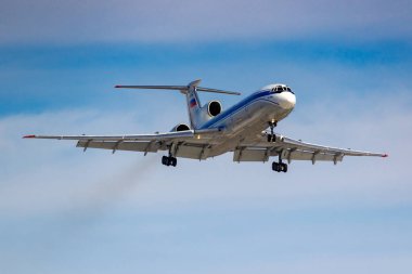 Moscow, Russia - March 14, 2019: Aircraft Tupolev Tu-154M RA-85084 of Russian Federation Air Force going to landing at Vnukovo airport in Moscow on a blue sky background at sunny day clipart