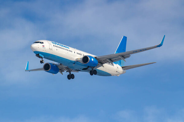 Moscow, Russia - March 14, 2019: Aircraft Boeing 737-800 VQ-BTG of Pobeda Airine going to landing at Vnukovo airport in Moscow on a blue sky background at sunny morning