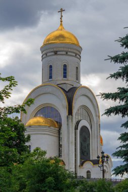 Moskova, Rusya-Haziran 09, 2018: kilise büyük şehit George Victorious üzerinde Poklonnaya Hill Moskova 'da yeşil ağaçlar ve bulutlu gökyüzüne karşı