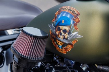 Moskova, Rusya - 04 Mayıs 2019: Harley Davidson motosikletinin mat yeşil yakıt tankı, Rus paraşütçülerinin mavi bereli kafatası ve None But Us yazımı. Moto festivali Mosmotofest 2019