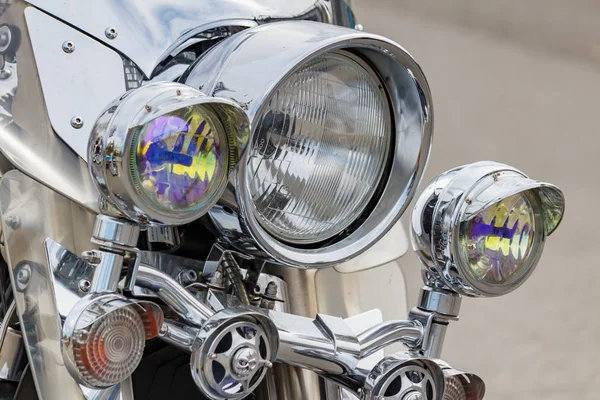 Moscow, Russia - May 04, 2019: Chrome headlights with direction indicators of Harley Davidson motorcycle closeup. Moto festival MosMotoFest 2019