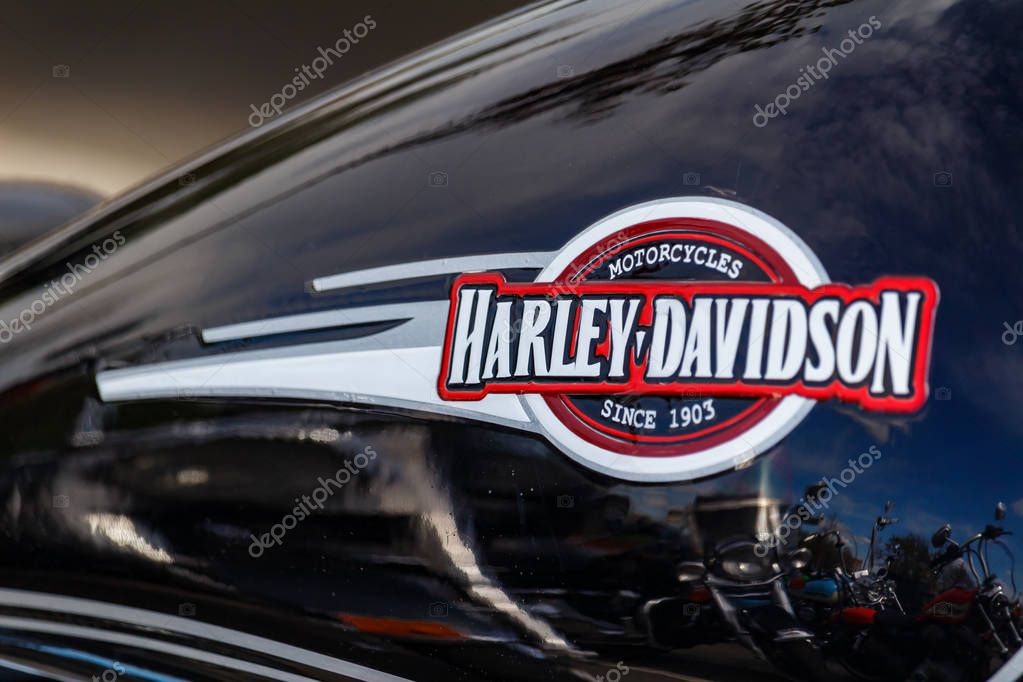 Moscow, Russia - May 04, 2019: Emblem of Harley Davidson motorcycles on the glossy black fuel tank closeup. Moto festival MosMotoFest 2019