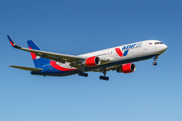 Moscow, Russia - May 19, 2019: Aircraft Boeing 767-3Y0(ER)(WL) VP-BUX of Azur Air airline landing at Vnukovo international airport in Moscow on a blue sky background at sunny day