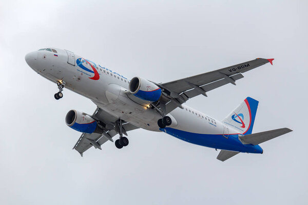 Moscow, Russia - March 17, 2019: Aircraft Airbus A320-214 VQ-BDM of Ural Airlines going to landing at Domodedovo international airport in Moscow against gray sky on a cloudy day