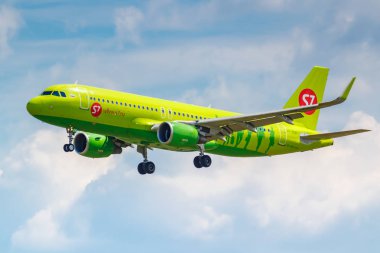 Moscow, Russia - June 21, 2019: Aircraft Airbus A320-214(WL) VP-BOM of S7 Siberia Airlines landing at Domodedovo international airport in Moscow on a cloudy blue sky background at sunny day clipart