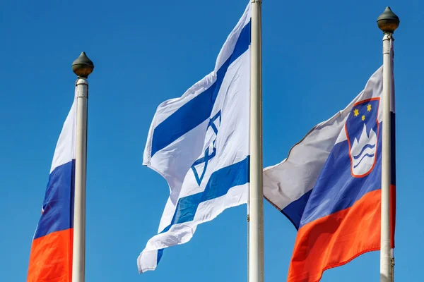 Flag of Israel on a background of flags of different countries in sunny day — Stock Photo, Image
