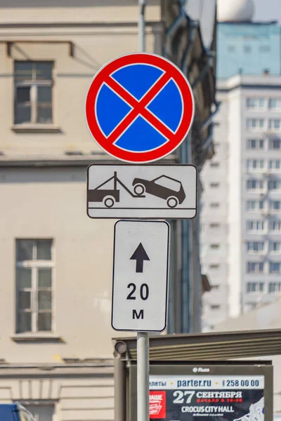 Moskva, Ryssland-september 13, 2019: vägskylt som förbjuder ett stopp av bilen med bärgningsbil underteckna på Moscow Street mot fasaden av byggnaden på Sunny Day — Stockfoto