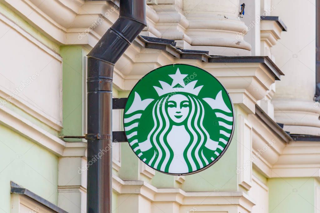 Moscow, Russia - September 13, 2019: Starbucks round sign with image of the two-tailed mermaid Siren on a green background. Contemporary Starbucks sign
