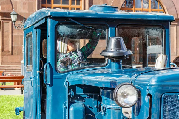 Moskow, Rusia - Oktober 08, 2019: Anak muda di kabin traktor crawler vintage soviet pada pameran mesin pertanian di Revolution Square di Moskow — Stok Foto