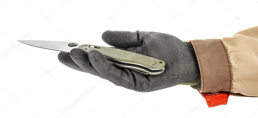 Open pocket folding knife with dark green handle lies in palm of worker hand in black protective glove and brown uniform isolated on white background