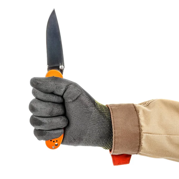 Open pocket folding knife with bright orange handle clenched in a worker fist in black protective glove isolated on white background