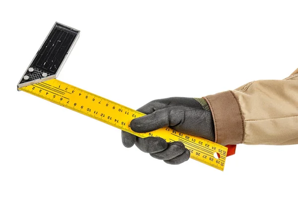 Yellow metal right angled ruler in worker hand in black protective glove and brown uniform isolated on white background