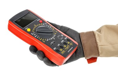 Elektrikçide kırmızı kauçuk koruyucu kılıflı dijital çoklu metre. Siyah koruyucu eldiven ve beyaz arka planda izole edilmiş kahverengi üniforma.