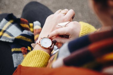 sokak tarzı moda ayrıntılar. yakın, bir kazak ve analog kol saati giyen genç moda blogger. şık kadın saati zamanında kontrol. Sonbahar/sonbahar sezon.