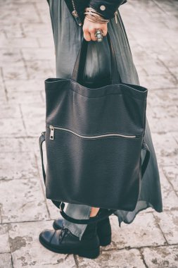 daha düşük vücut detay jewlery, bir elbise giymiş ve büyük bir siyah çanta onun elinde tutan şık bir kadın