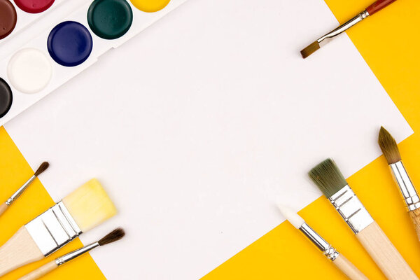 Top view of creating watercolor painting, blank sheet of watercolor paints. Copy space flatlay