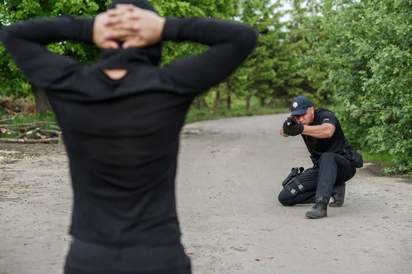 Policista Zaměření Terorista Pachatel Kolenou Rukama Složené Nad Hlavou — Stock fotografie