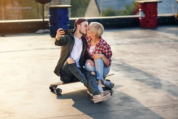 Handsome Young Couple Sitting Longboard Skateboard Rooftop Industrial Building Making — Stock Photo, Image