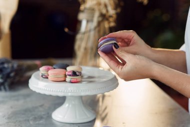 Pudra macarons parçaları birbirleri ile bir krem kullanarak katılır. Macarons yapmak baker eller yukarı kapatın.