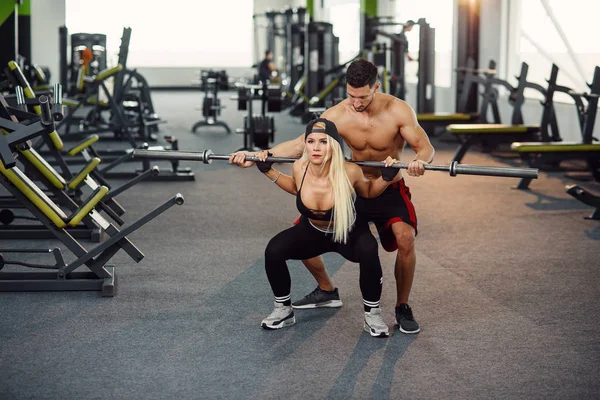 Hermosa Chica Haciendo Sentadillas Bajo Supervisión Del Entrenador Una Pareja — Foto de Stock