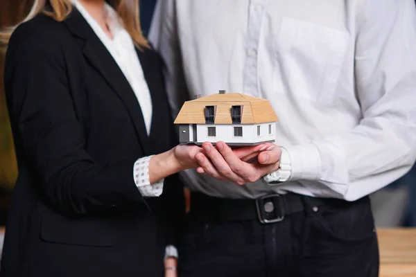 Young couple, realtor holding 3d model of house. — Stock Photo, Image
