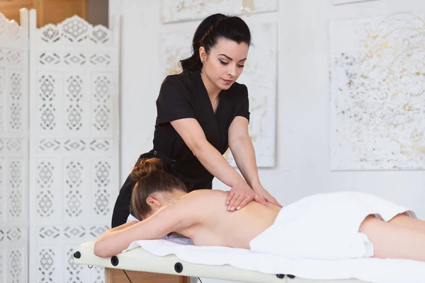 Spa salonunda arka Masssage sırasında rahatlatıcı genç kadın. — Stok fotoğraf