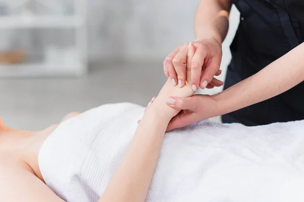 Hand massage. Physiotherapist pressing specific spots on female palm. Professional health and wellness acupressure manipulations, copy space, closeup — Stock Photo, Image