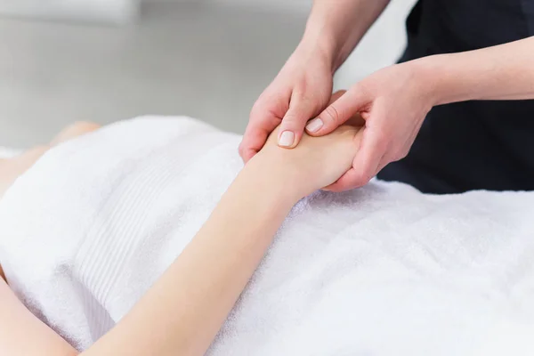 Hand massage. Physiotherapist pressing specific spots on female palm. Professional health and wellness acupressure manipulations, copy space, closeup — Stock Photo, Image
