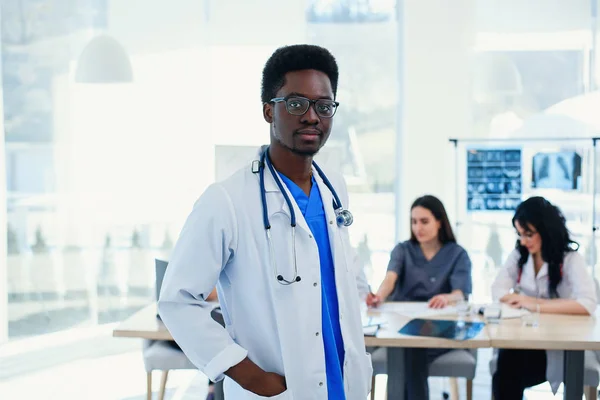 Serious African American doctor portrait. Portrait of medical assistant with stethoscope. Male doctor with a medical group at the hospital.