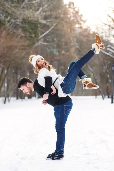 Young loving couple on natural winter background. New Year and Christmas. — Stock Photo, Image