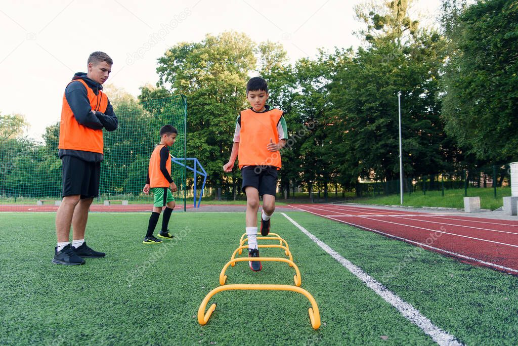 Childrens football players during team training before an important match. Exercises for the youth football team.