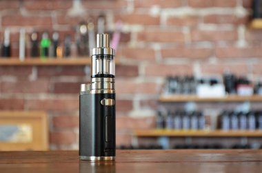 Yelek dükkanının arka planında elektronik sigara. Vaping için e-sigara. Popüler Vape aygıtları