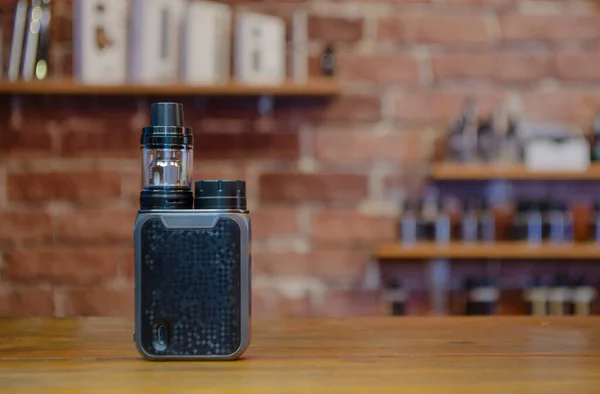 Yelek dükkanının arka planında elektronik sigara. Vaping için e-sigara. Popüler Vape aygıtları