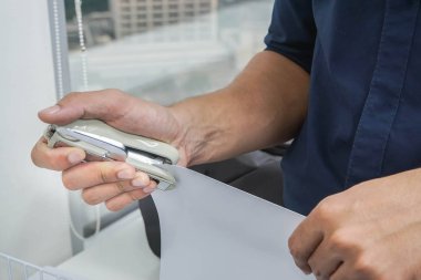 ofiste sipariş belgeleri için zımba ile işadamı el yakın yukarı