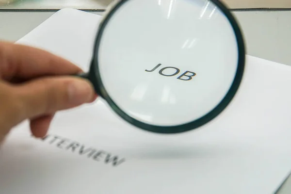 business concept of job hunting and interview by magnifying glass