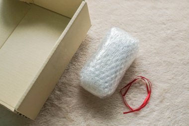 parsel için kabarcık sayfasında kırmızı kurdele ve karton paket hediye