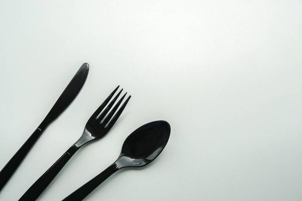 isolated black plastic cutlery for meal