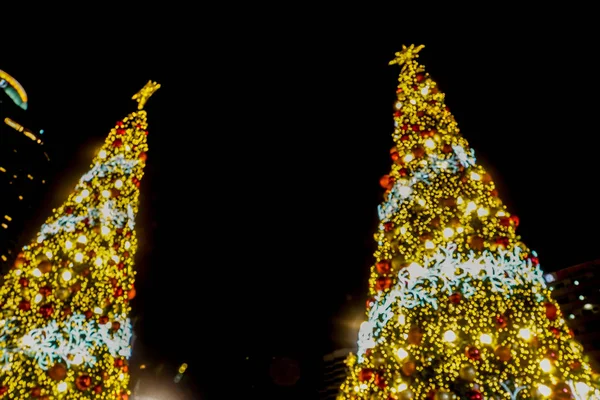 blurred bokeh sparkling light Christmas tree at shopping mall for season's greetings