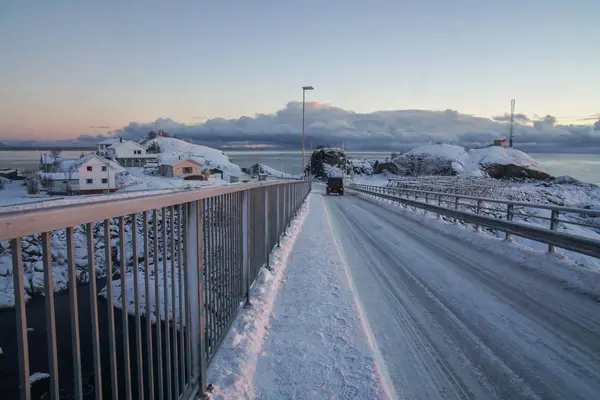 white slippery snowy road run across the bridge in Lofoten Islands, Norway