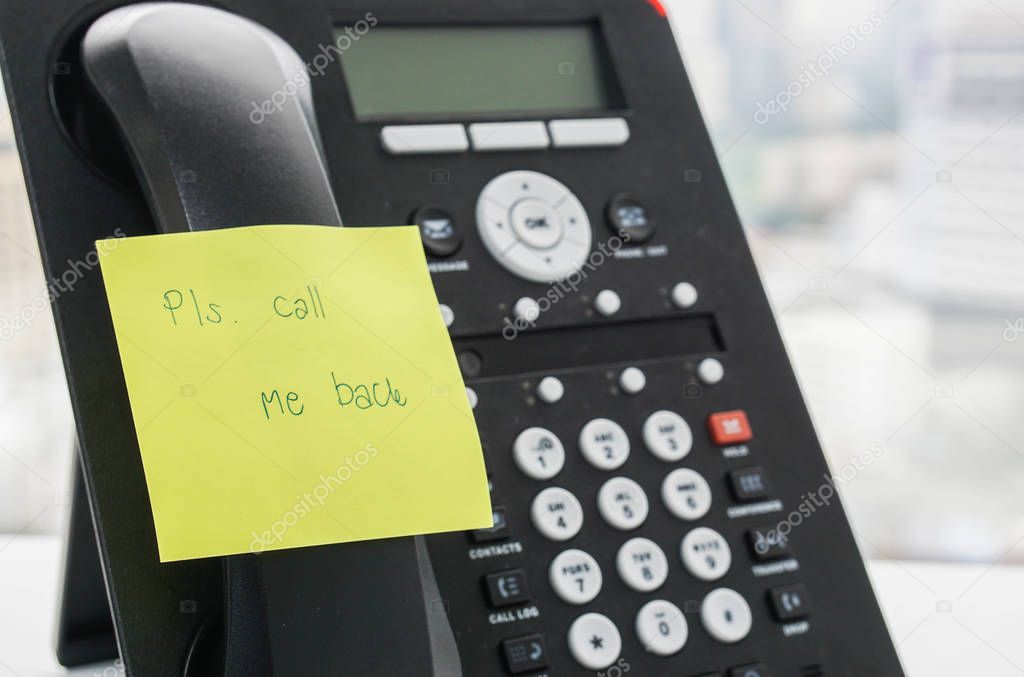 IP phone headset with calling back message on sticky note for reminder