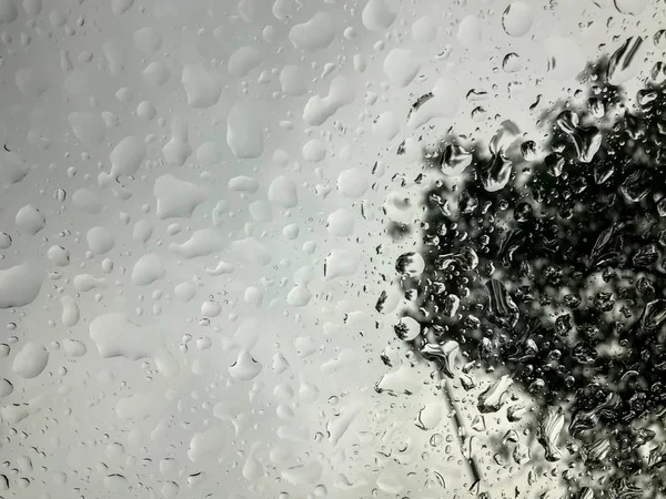 noise and selective focus of raindrops on car wind shield in stormy day