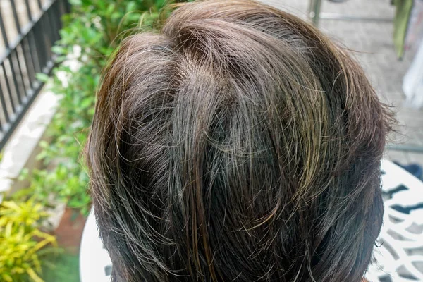 selective focus close up grey hair of old woman with dye