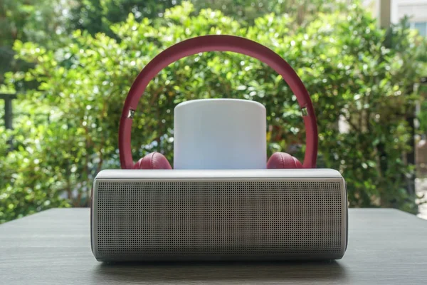 close up wireless speaker with pink headphones for music listening in freetime