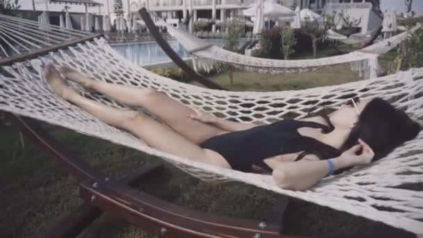 女孩躺在吊床上 — 图库视频影像