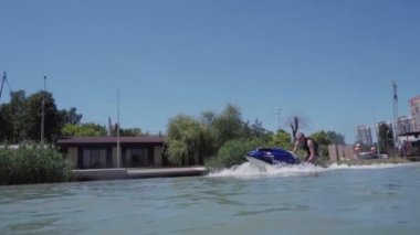 Genç bir adam bir hydrocycle gölde biniyor